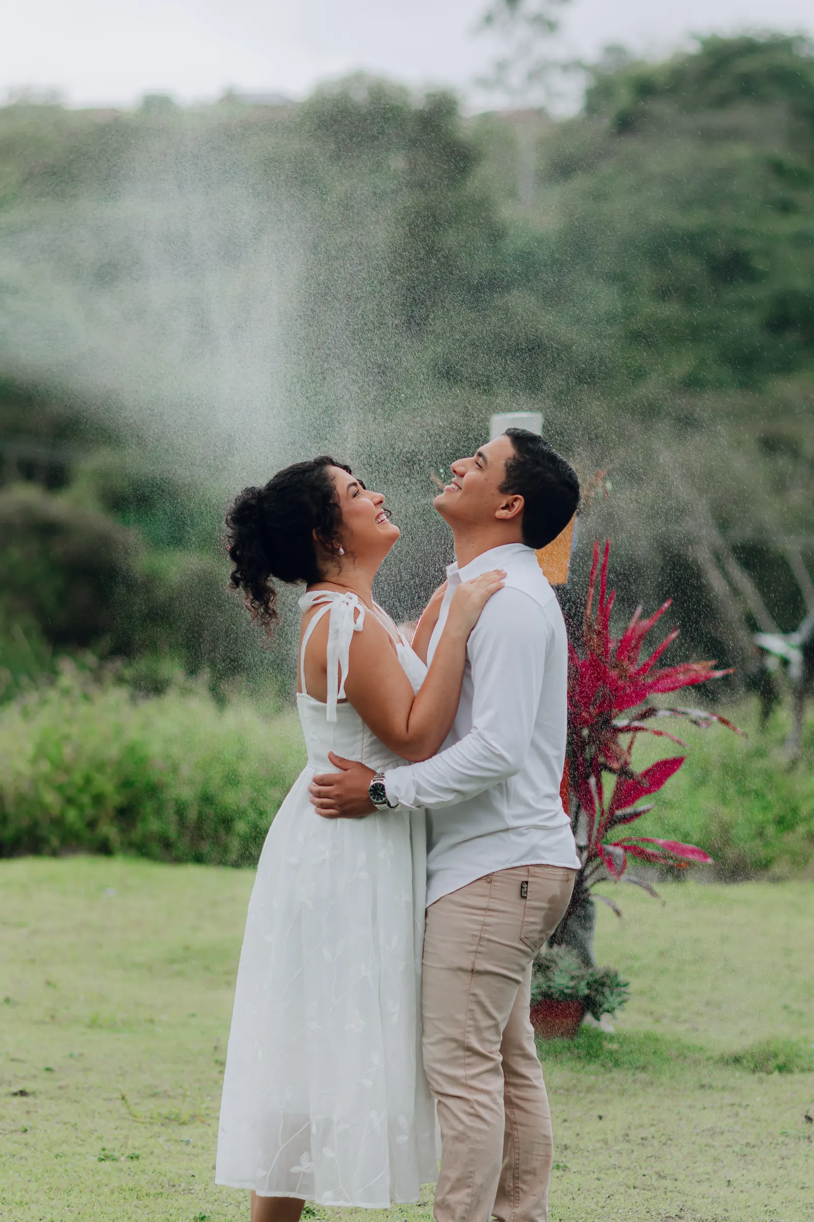 Paula e André sorrindo sob a chuva
